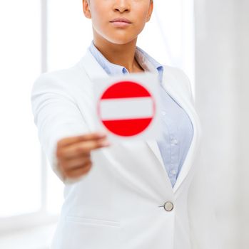 business, protest, racism concept - african woman showing stop sign