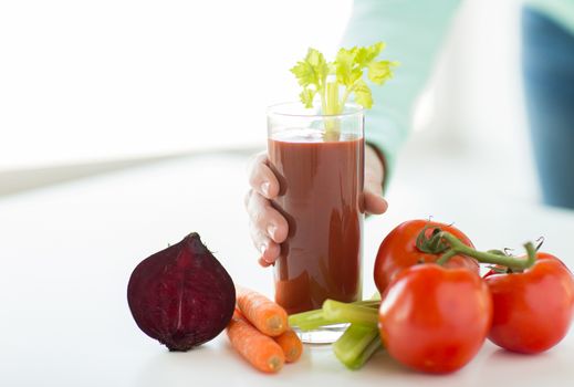 healthy eating, food, dieting and people concept - close up of woman hands with tomato juice and vegetables