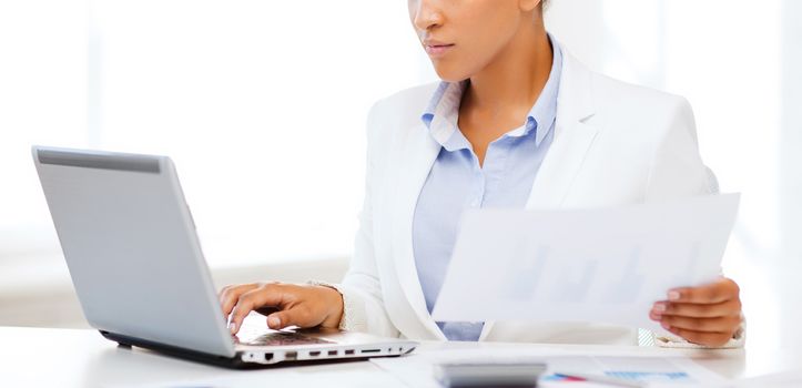 business and tax concept - african businesswoman working with computer in office
