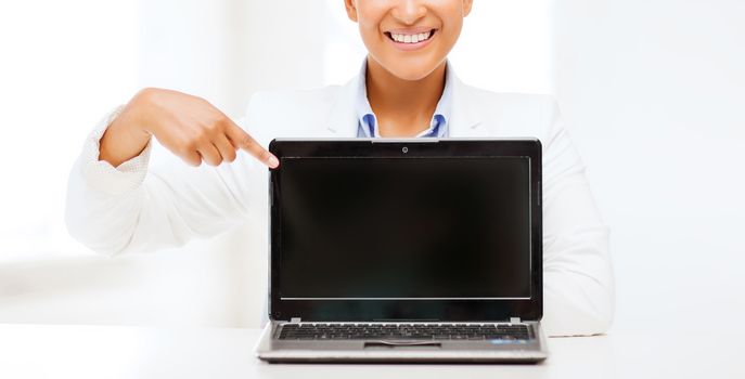 education,business, technology and internet concept - smiling woman with laptop computer