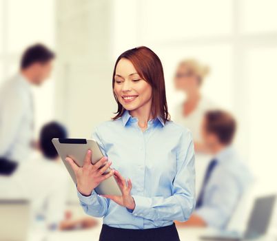 business, internet and technology concept - smiling woman looking at tablet pc computer at office