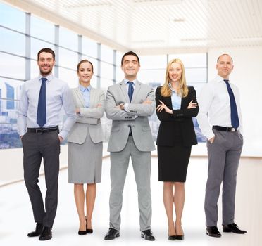 business, people, gesture and teamwork concept - group of smiling businessmen over office room background