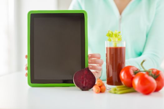healthy eating, technology, diet and people concept - close up of woman hands with tablet pc, tomato juice and vegetables
