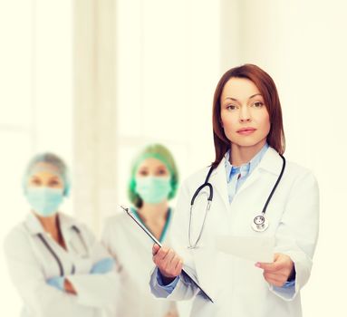 healthcare and medicine concept - calm female doctor with clipboard and stethoscope