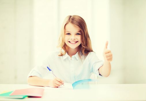 education and school concept - smiling student girl studying at school