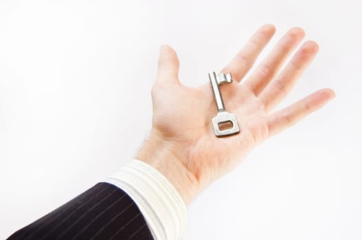 Key conceptual image. Man holds the key.