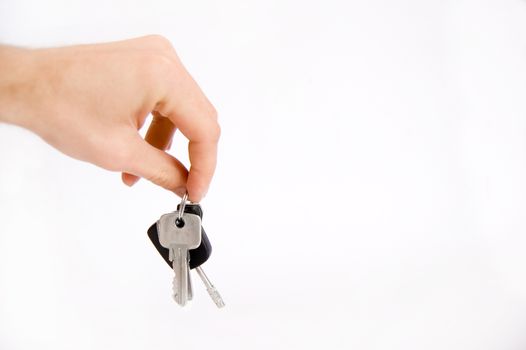 Hand holding keys on isolated background.