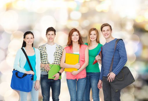 education and people concept - group of smiling students standing