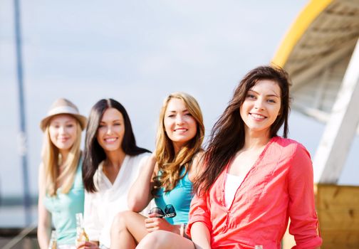 summer holidays and vacation - girls with drinks on the beach