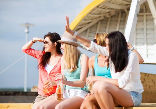 summer holidays and vacation - girls with drinks on the beach