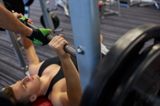 sport, fitness, teamwork, weightlifting and people concept - young man and personal trainer with barbell flexing muscles in gym