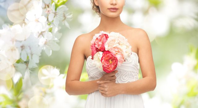 wedding, holidays, people and celebration concept- bride or woman with bouquet of flowers over summer garden and cherry blossom background