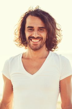 happiness, summer, advertising and people concept - smiling man in white blank shirt outdoors