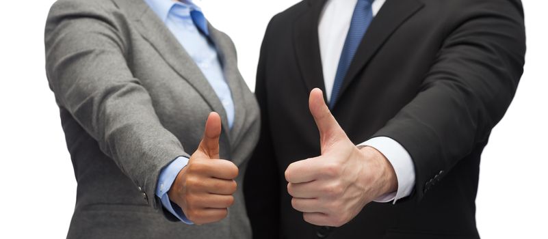 business and office concept - businessman and businesswoman showing thumbs up