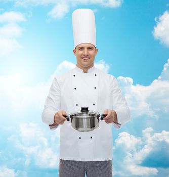 cooking, profession and people concept - happy male chef cook holding pot over blue sky with clouds background