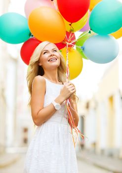 summer holidays, celebration and lifestyle concept - beautiful woman with colorful balloons in the city