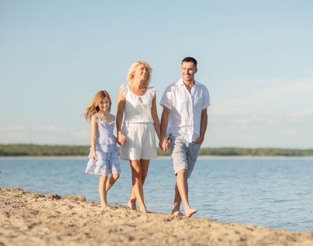 summer holidays, children and people concept - happy family at the seaside