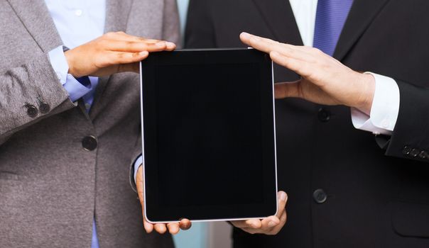 business, technology, internet and office concept - businessman and businesswoman with blank black tablet pc screen in office