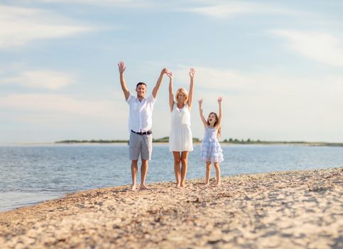 summer holidays, children and people concept - happy family at the seaside