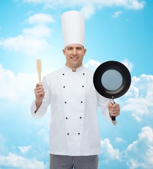 cooking, profession and people concept - happy male chef cook holding frying pan and spatula over blue sky with clouds background