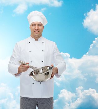 cooking, profession and people concept - happy male chef cook holding bowl and whipping something with whisk over blue sky with clouds background