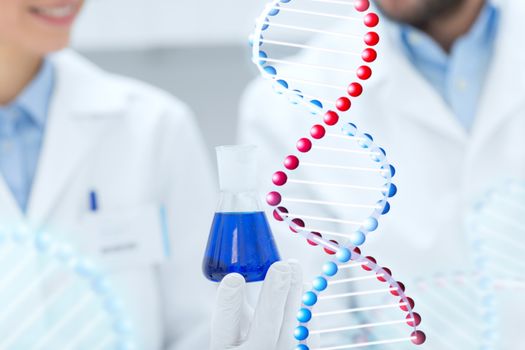 science, chemistry, biology, medicine and people concept - close up of scientists with test tube or glass flask making test or research in clinical laboratory