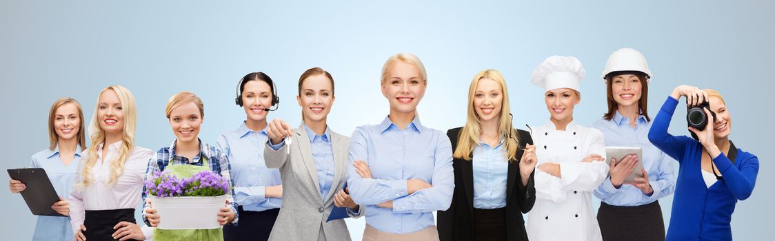 people, profession, qualification, employment and success concept - happy businesswoman with group of professional workers over blue background