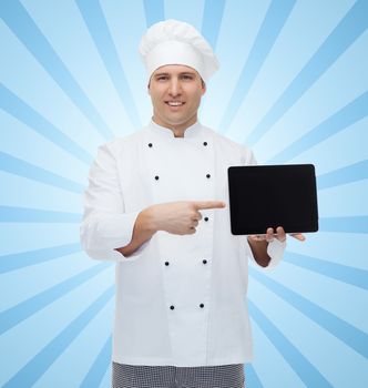 cooking, profession and people concept - happy male chef cook showing tablet pc computer black blank screen over blue burst rays background
