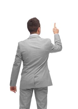 business, people, advertisement and office concept - businessman pointing finger or touching something imaginary from back