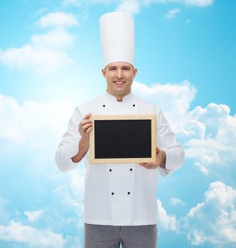 cooking, profession, advertisement and people concept - happy male chef cook showing and holding blank menu board over blue sky with clouds background