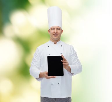 cooking, profession and people concept - happy male chef cook showing tablet pc computer black blank screen over green background