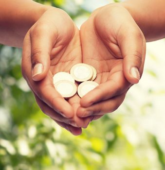 money and finances concept - close up of womans cupped hands showing euro coins