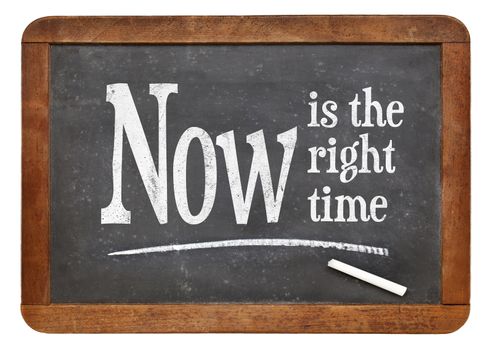 Now is the right time- motivational phrase on a vintage slate blackboard