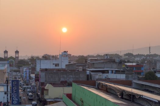 TUXTLA GUTIERREZ, MEXICO - FEBRUARY 11, 2014: The early morning sun glows over the marketplace and downtown area of Tuxtla Gutierrez in Chiapas, Mexico