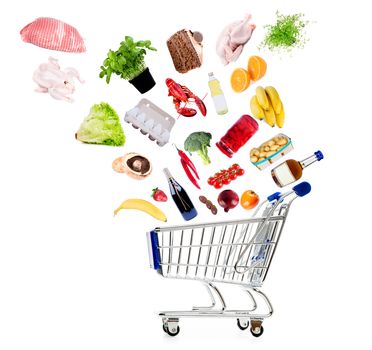 Shopping cart with grocery goods isolated on white