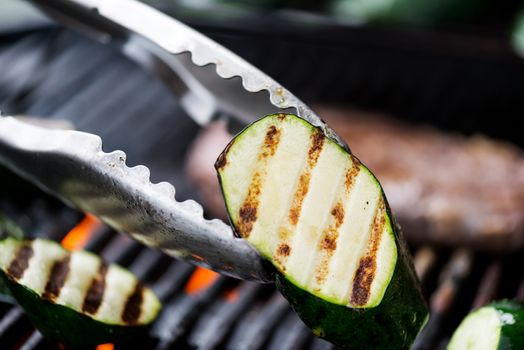 Cooking aubergine or eggplant on grill with olive oil. Delicious!