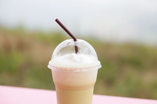 Coffee in plastic cup. Iced coffee in a plastic cup is placed on the table.