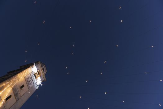 Bell Tower with Christmas lights and blue sky background, Leggiuno - Varese, Italy