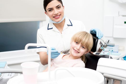 Girl child and dental hygienist at dental clinic