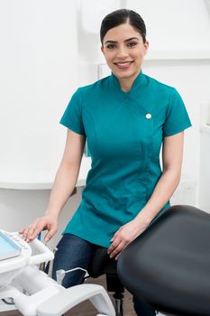 Female assistant seated in dental office