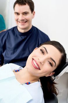 Pretty woman at dental clinic with male doctor 