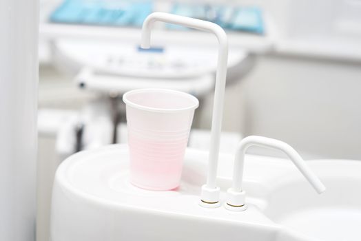 Close up of a cup under the sink at dental clinic