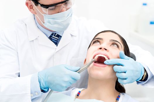 Female patient open her mouth during treatment