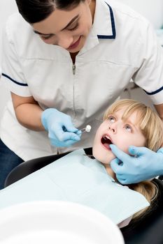Little girl undergoing dental treatment at clinic