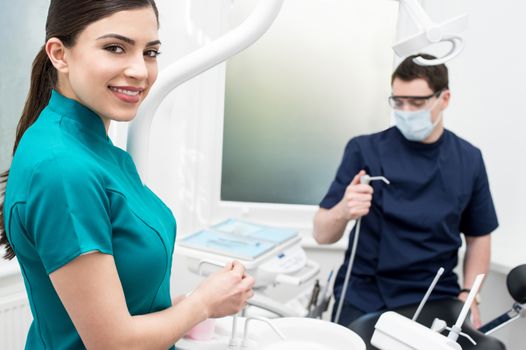 Male dentist and his female assistant posing