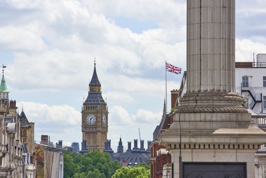 Cropped cityscape with Big Ben prominent in the background on a cloudy summer day in London, UK.