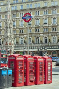 LONDON, UK - JUNE 15: Four traditional red phone booth with underground sign in front of Charing Cross station. June 15, 2015 in London.