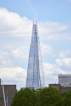 LONDON, UK - JUNE 15: The Shard seen from the South Bank, with cloudy blue sky in the background. June 15, 2015 in London.