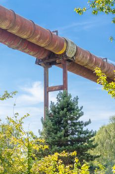 industrial pipelines, pipelines in an old factory plant against blue sky.