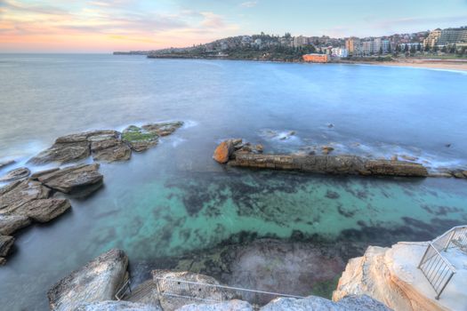High views from the cliff top overlooking the northern rockpool at Coogee in Sydney's eastern suburbs.  Giles Baths is a natural rock pool, known as the Bogey hole  and beyond are its three southern rock pools